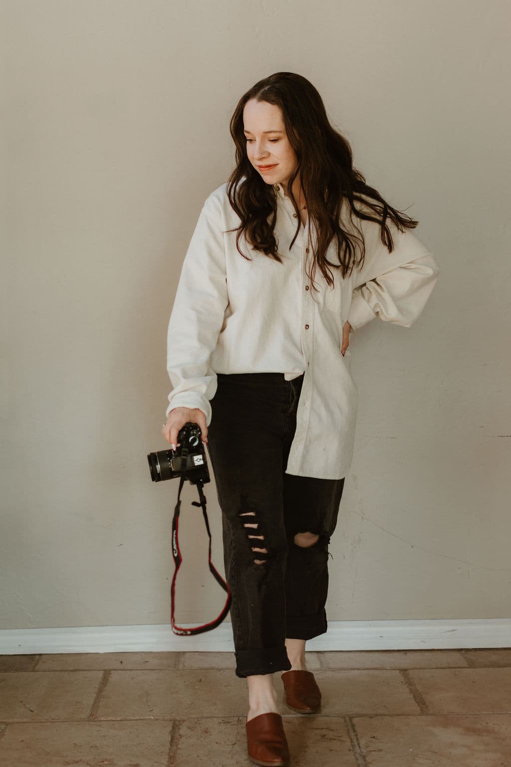 Lauren standing with camera at her side