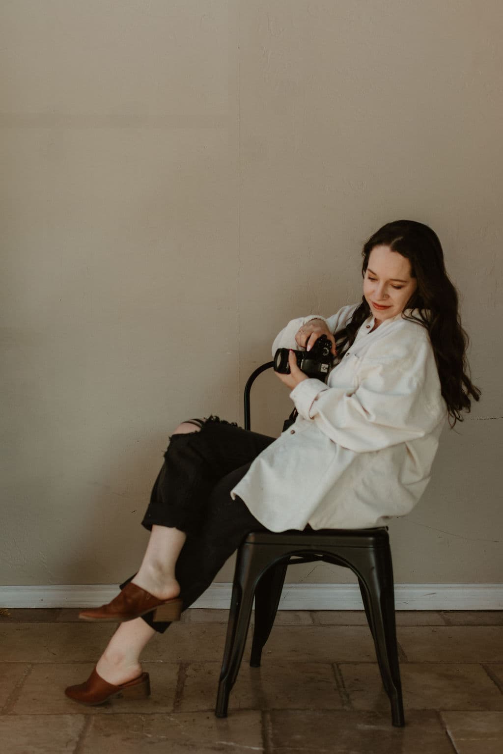 Lauren seated with camera, looking down