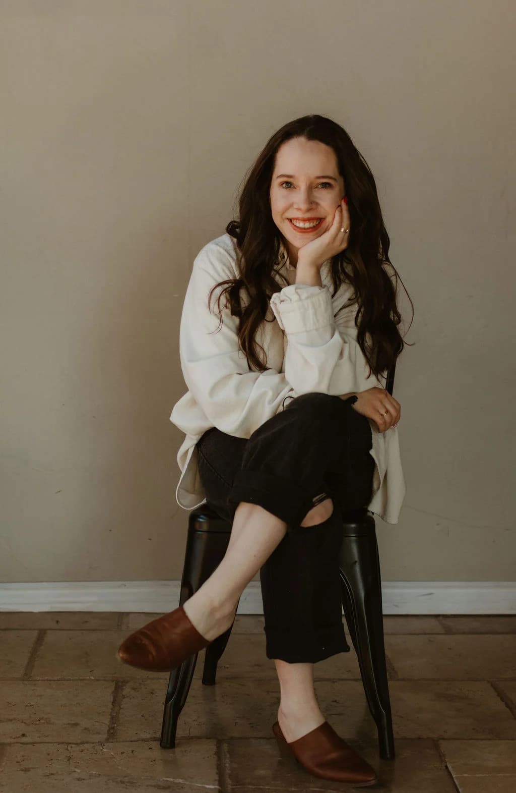 Lauren smiling, chin resting on hand