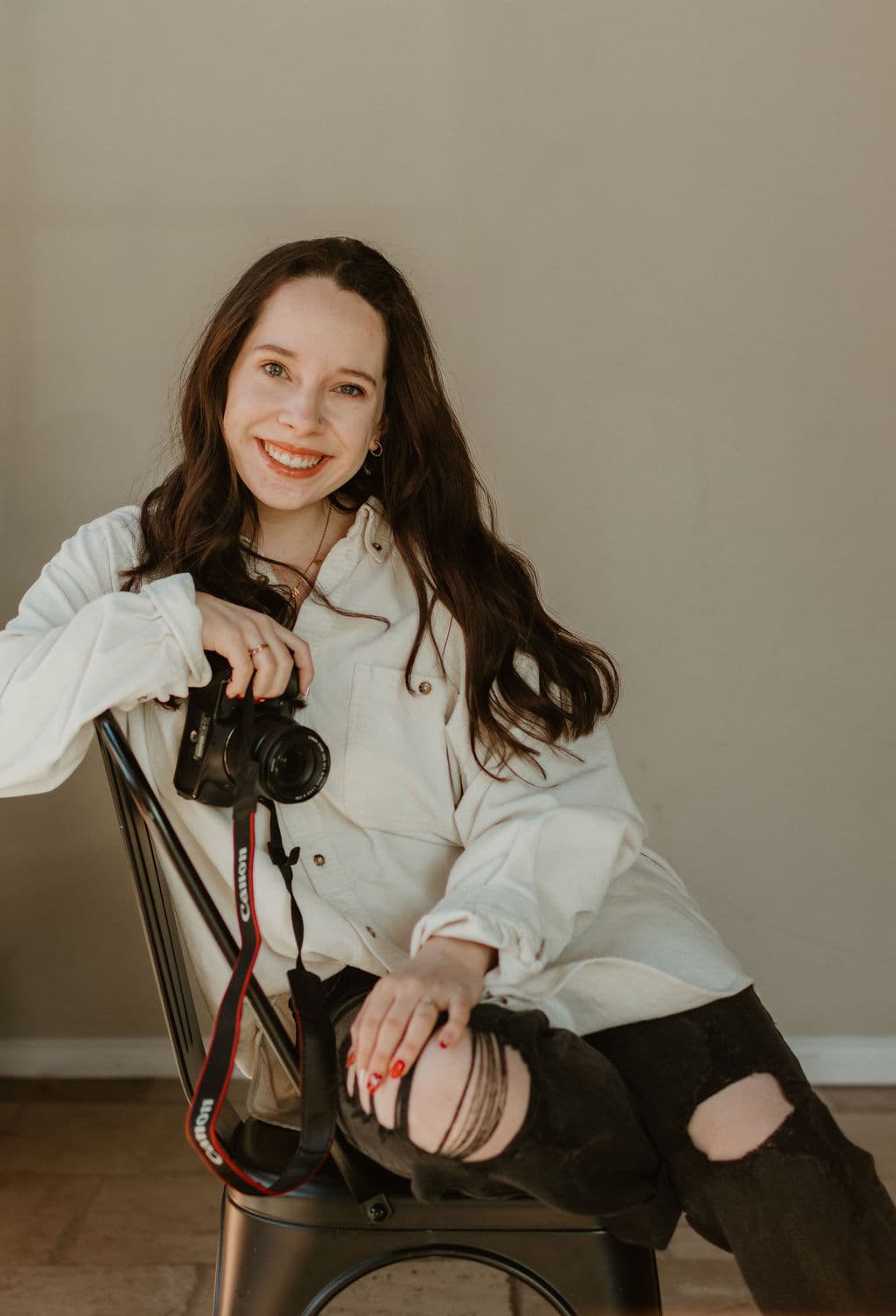 Lauren Mitchell smiling with her camera